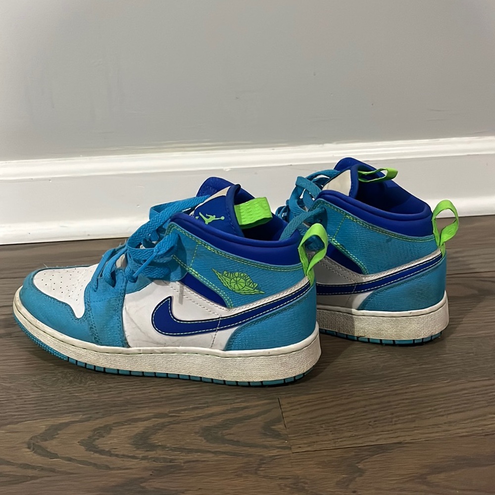 Worn blue and green Jordan 1 mids